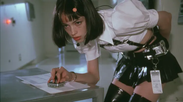 a young Caucasian American woman with pale skin and light freckles, a glossy black blunt jaw-length bob with heavy bangs and one clay-orange streak through the bangs, a small flat clay-orange eight-pointed star hair…
